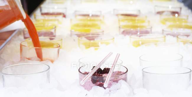 Closeup view of assorted fruit shakes in ice — Stock Photo