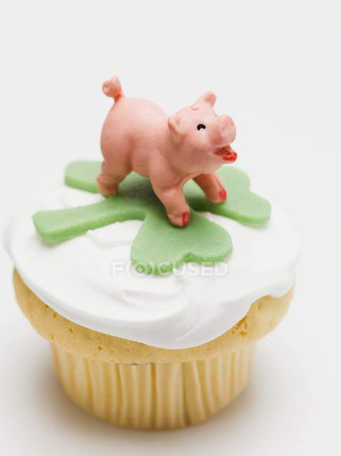 Cupcake decorated with charms — Stock Photo