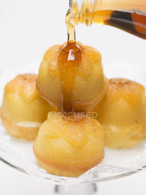 Closeup view of soaking babas in maple syrup — Stock Photo