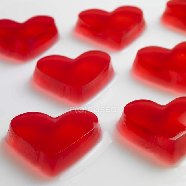 Red raspberry jelly hearts — Stock Photo