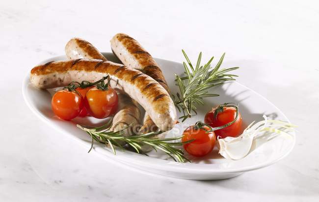 Grilled sausages with fresh tomatoes — Stock Photo