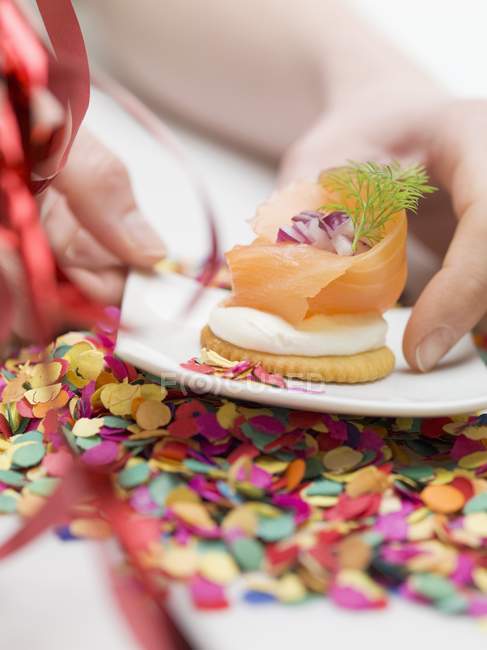 Копчений лосось на крекері на тарілці — стокове фото