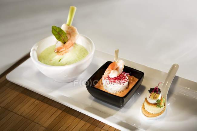 Closeup view of seafood appetizers on white platter — Stock Photo