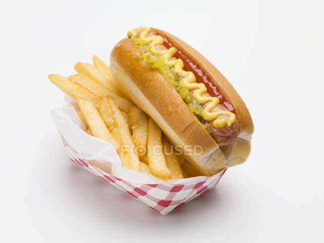Hot dog with fries in paper dish — Stock Photo