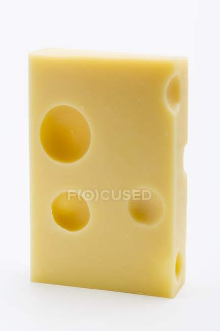 Piece of Emmental cheese over white — Stock Photo