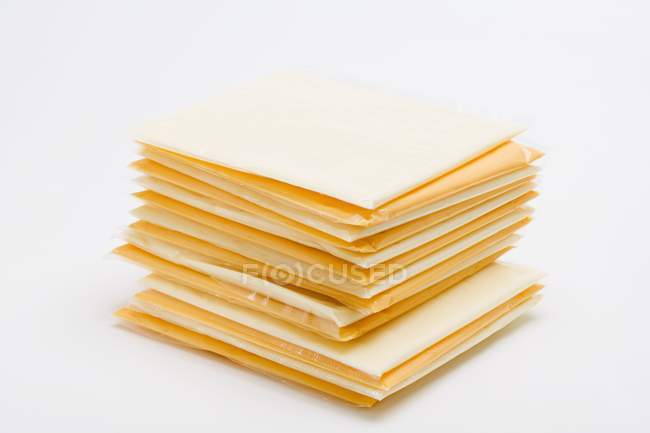 Fatias de queijo embrulhadas em plástico — Fotografia de Stock