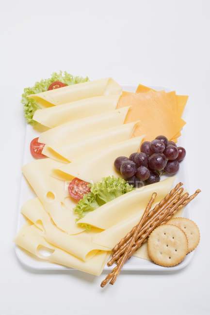 Cheese platter with grapes — Stock Photo