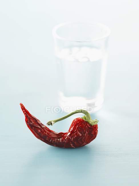 Dried chili and glass of water — Stock Photo