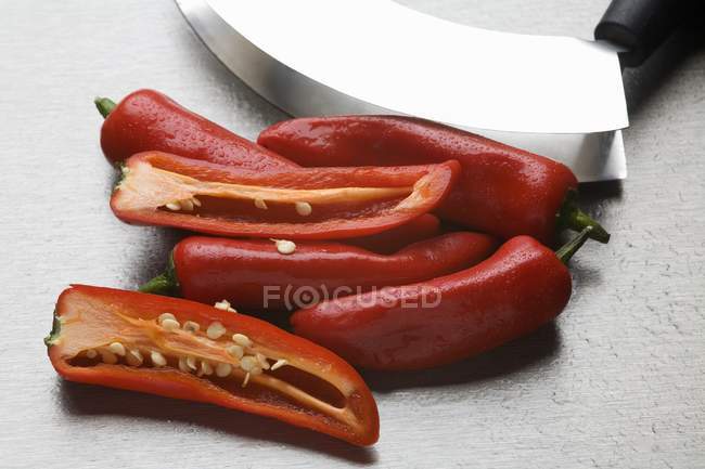 Red chillies with mezzaluna — Stock Photo