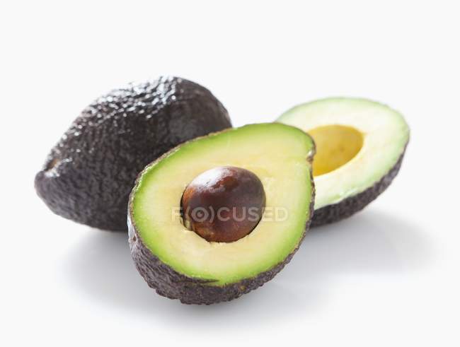 Fresh avocado with halves — Stock Photo