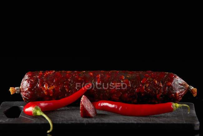 Salami sausage and chili — Stock Photo