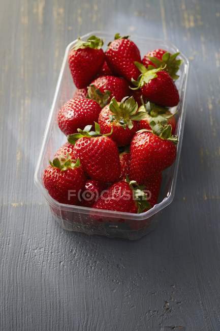 Fresh strawberries in plastic punnet — Stock Photo