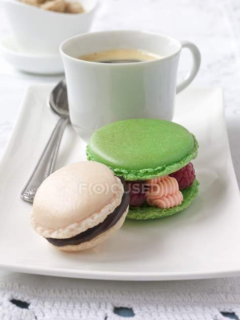 Macaroons with coffee in cup — Stock Photo