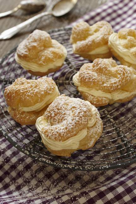 Profiteroles dusted with icing sugar — Stock Photo