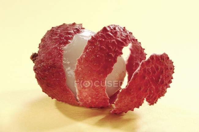 Fresh partly peeled lychee — Stock Photo