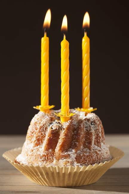 Bundt cake with lit candles — Stock Photo
