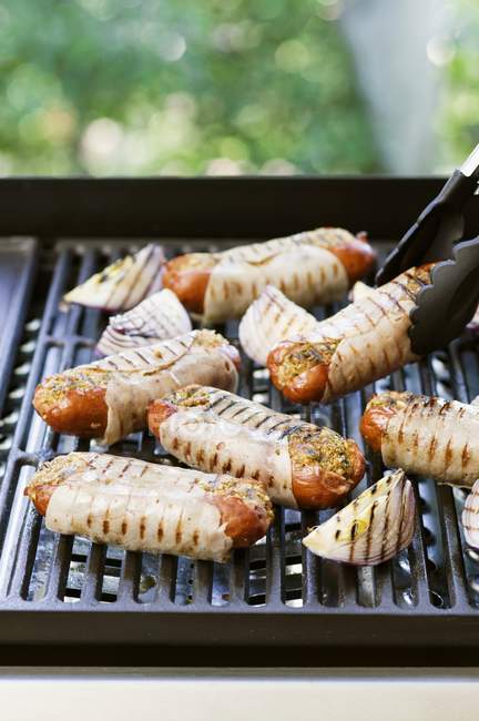 Stuffed sausages wrapped in ham — Stock Photo