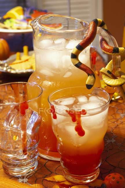 Halloween punch in pitcher and glasses — Stock Photo