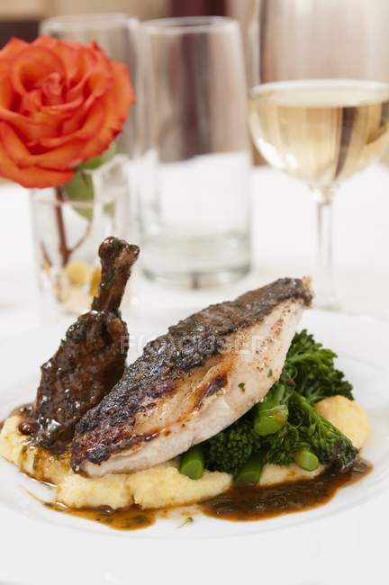 Charred Chicken with Broccoli Rabe Over Mashed Potatoes on white plate — Stock Photo