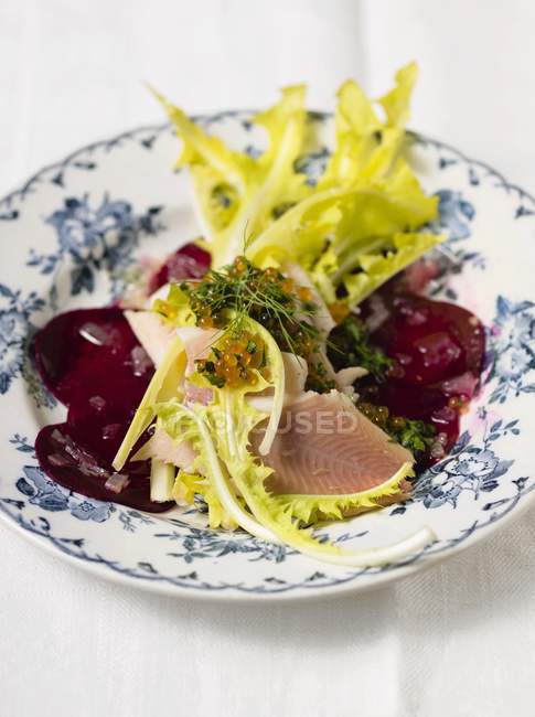 Closeup view of dandelion salad with smoked trout, trout caviar and beetroot — Stock Photo