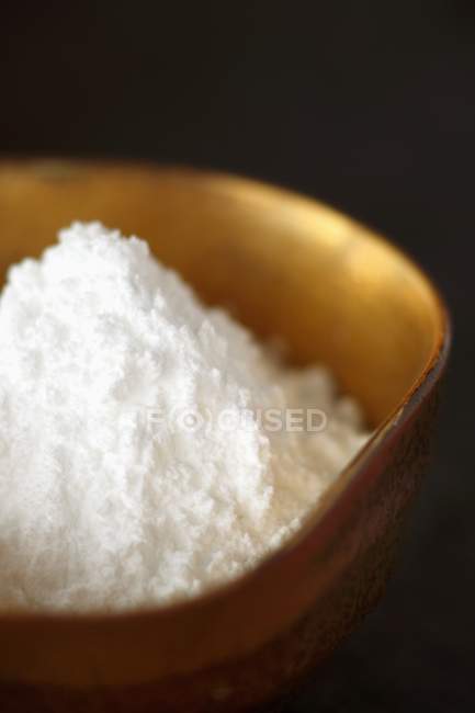 Confectioners Sugar in Golden Bowl — Stock Photo