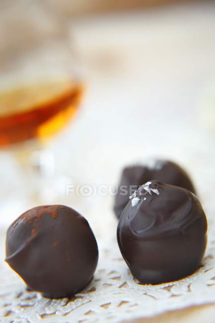 Closeup view of three chocolate truffles — Stock Photo