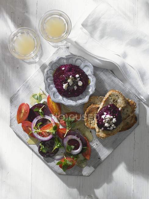 Beetroot dip with tomato salad — Stock Photo