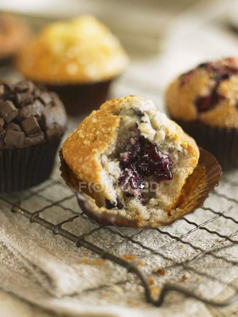 Half eaten blueberry muffin — Stock Photo