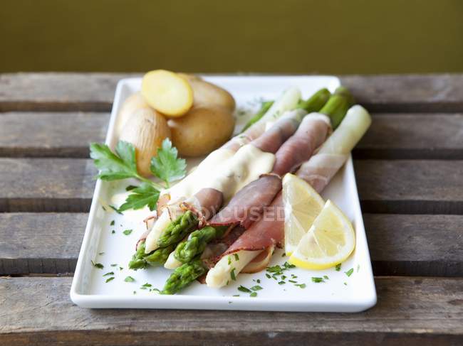 Asparagus wrapped in ham — Stock Photo
