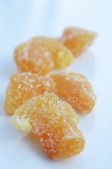 Closeup view of candied ginger on white background — Stock Photo
