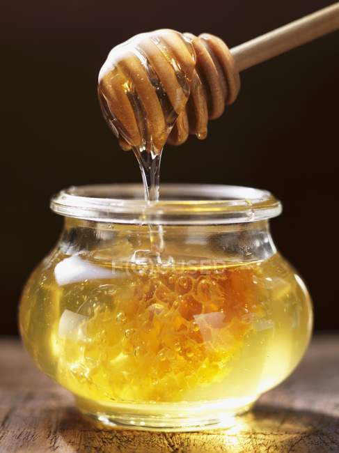 Мед капает с ложки — стоковое фото