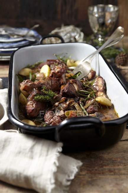 Closeup view of Coq au vin woth herbs in roasting tin — Stock Photo