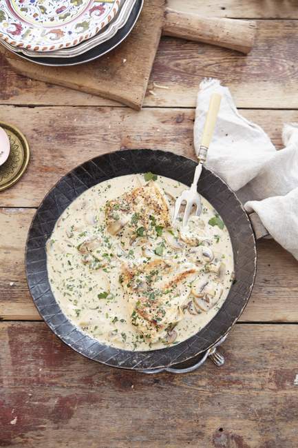 Top view of chicken and herbs in creamy sauce — Stock Photo