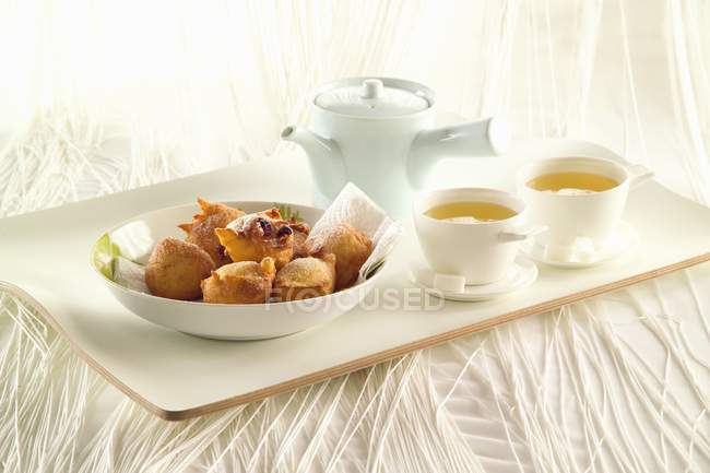 Churros and tea on the tray — Stock Photo