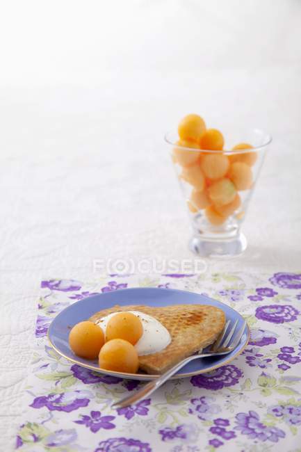 Pancake with yoghurt on plate — Stock Photo