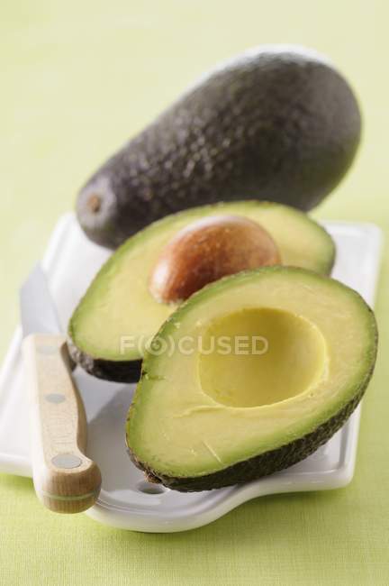 Fresh avocado with halves — Stock Photo