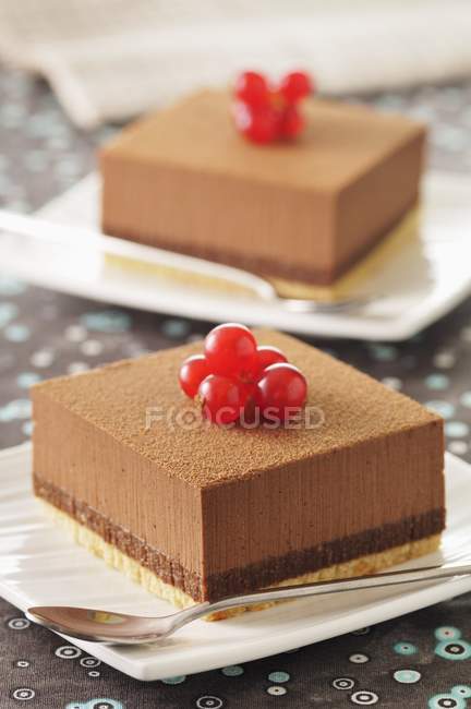 Chocolate slices on plates — Stock Photo