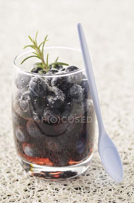 Blueberries in red wine with rosemary — Stock Photo