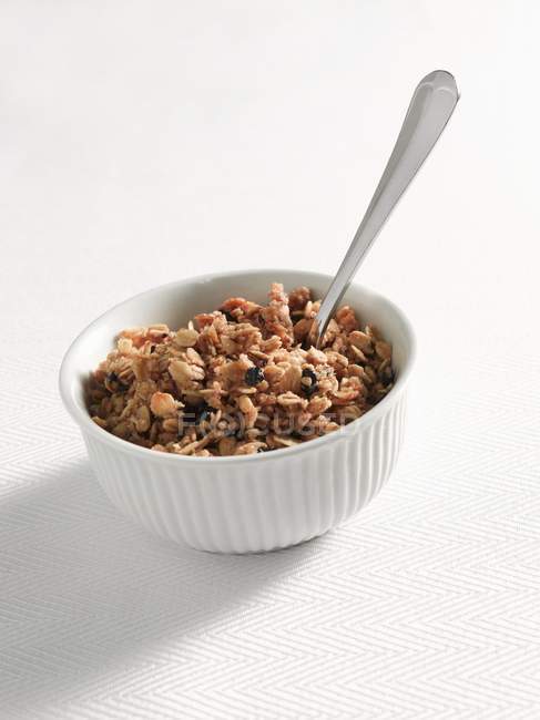 Bowl of granola with spoon — Stock Photo