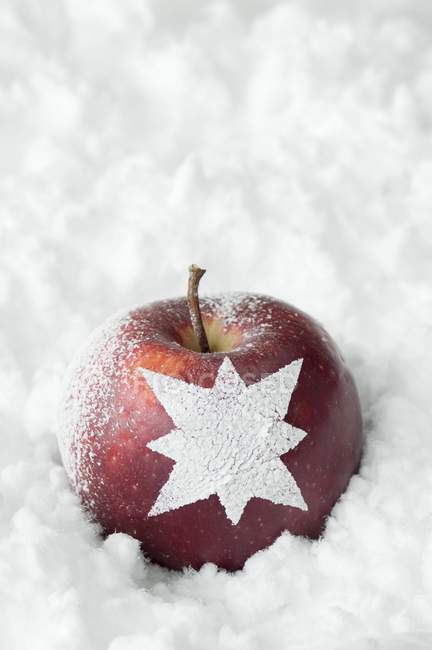 Christmas apple with star ornament — Stock Photo