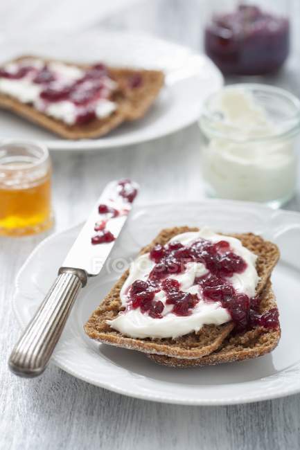 Breads with crme fraiche and jam — Stock Photo