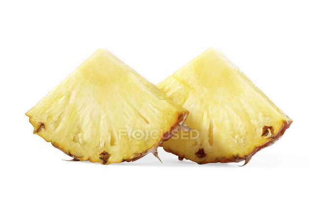 Chunks of pineapple on white — Stock Photo