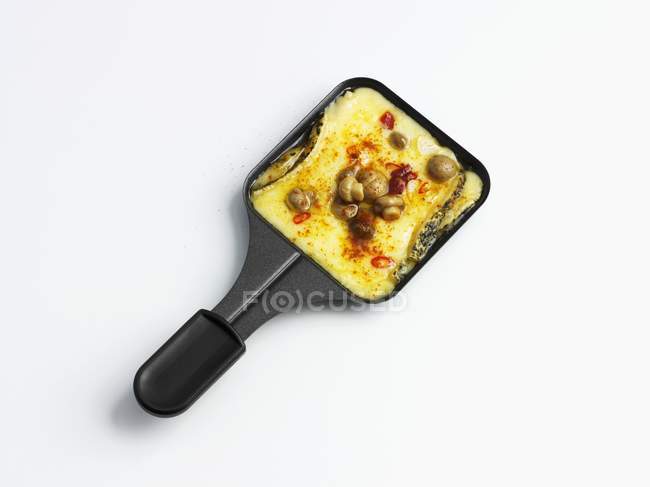 Raclette with mushrooms on platter — Stock Photo