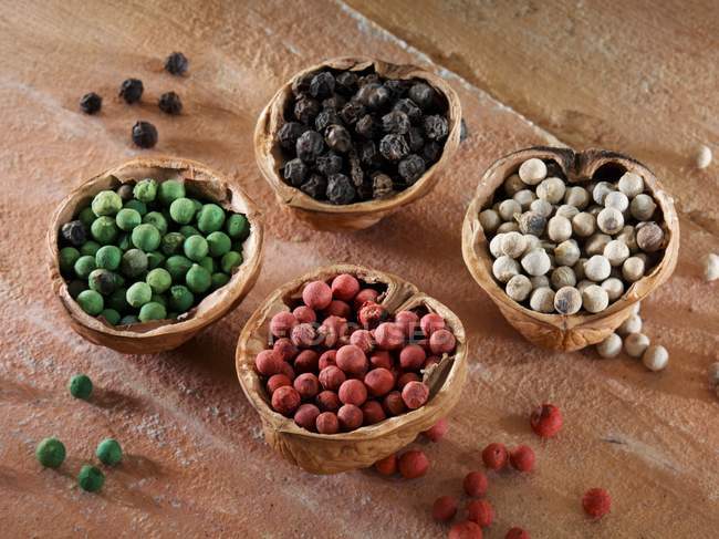 Colourful peppercorns in shells — Stock Photo