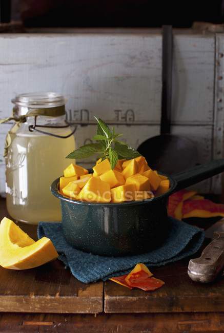 Cubed Red Hubbard Squash in a Bowl over wooden surface of table — Stock Photo