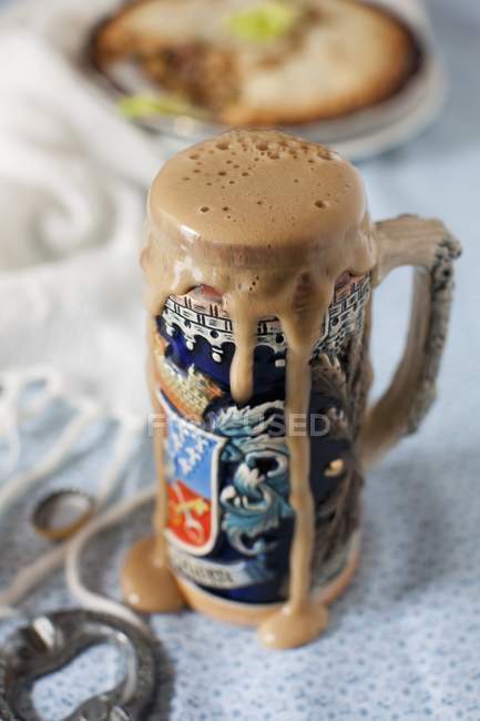 Stein of Beer Overflowing — Stock Photo