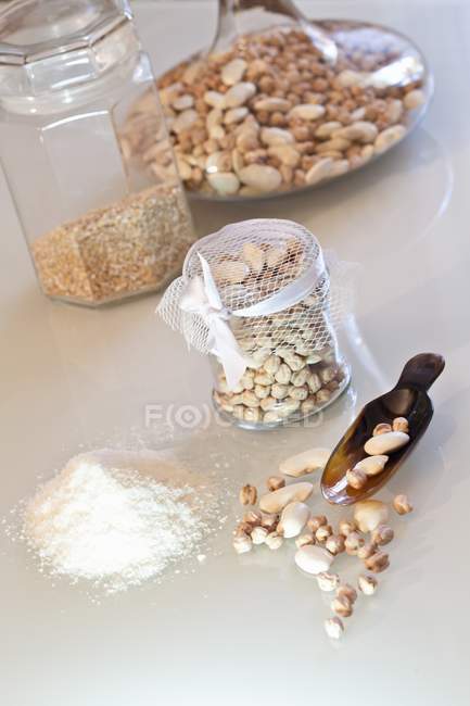 Dried beans, chickpeas and semolina  on white surface — Stock Photo