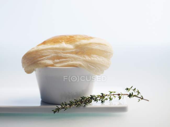 Closeup view of soup in a bowl with a puff pastry lid — Stock Photo