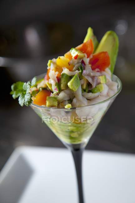 Ceviche with avocado in a stemmed glass — Stock Photo
