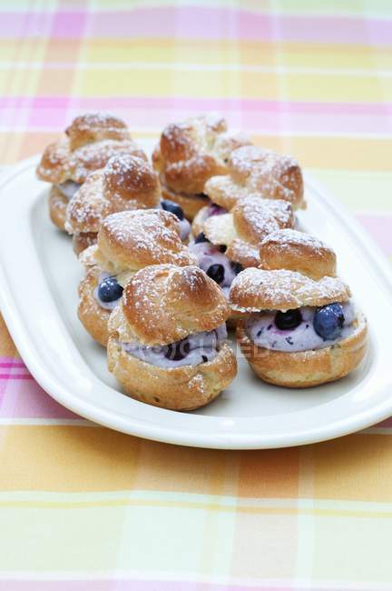 Profiteroles filled with blueberries — Stock Photo